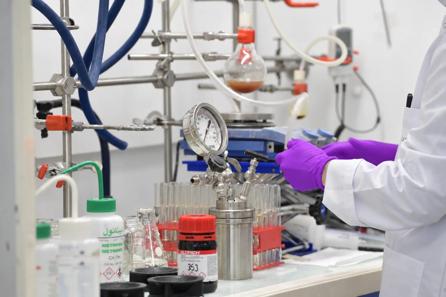 Oxeltis chemist setting up a reaction on a laboratory bench